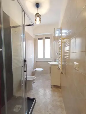 a bathroom with a shower and a toilet and a sink at La Dimora di Magi in Rome