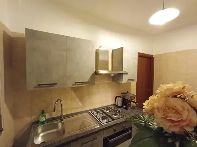 a kitchen with a sink and a stove at La Dimora di Magi in Rome