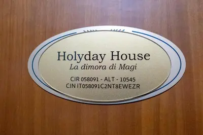a plaque on the door of a holiday house at La Dimora di Magi in Rome
