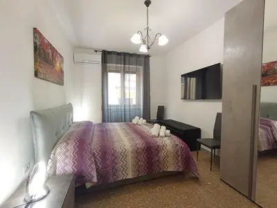 a bedroom with a bed and a desk and a television at La Dimora di Magi in Rome