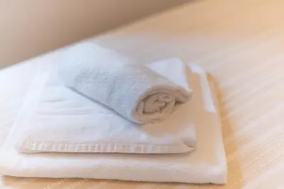 a stack of white towels sitting on a table at Evelina in Trastevere in Rome