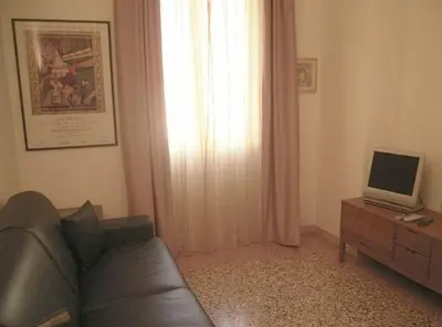 a living room with a couch and a television at Cathy Apartment in Rome