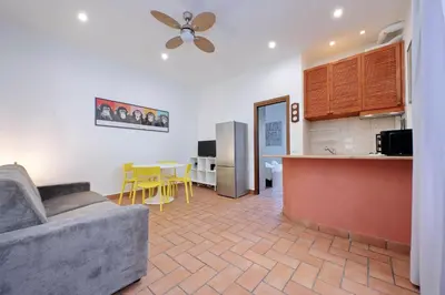 a living room with a couch and a kitchen at Homs Apartment In Rome by Halldis in Rome