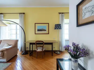 a living room with a table and a couch at Porta Pia Elegant Two Bedroom in Rome
