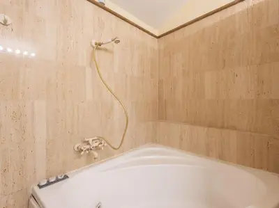 a bathroom with a bath tub with a shower at Porta Pia Elegant Two Bedroom in Rome