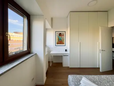 a bedroom with a window and a table and a desk at The Twenty - Villaggio Olimpico apartment in Rome