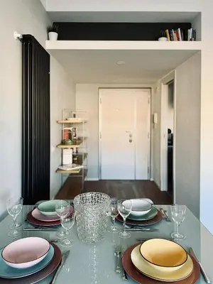 a table with plates and wine glasses on it at The Twenty - Villaggio Olimpico apartment in Rome