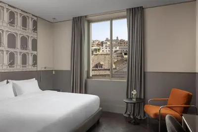 a hotel room with a bed and a window at Radisson Collection Hotel, Roma Antica in Rome