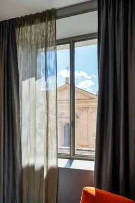 a window with a view of a building at Radisson Collection Hotel, Roma Antica in Rome