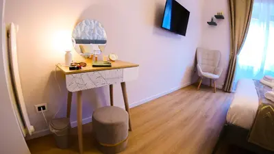 a room with a desk with a mirror and a bed at Baronio Apartment in Rome