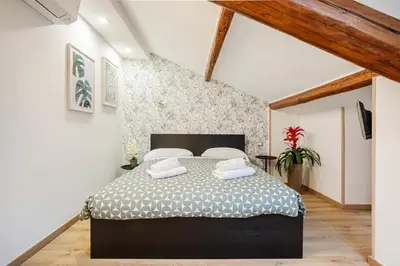 a bedroom with a large bed in a attic at Vatican Vittoria Suites - Vatican museums in Rome