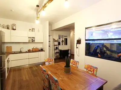 a kitchen and dining room with a table and a fish tank at Rooftop Appia antica,silenzioso riservato two bedrooms two bathrooms in Rome