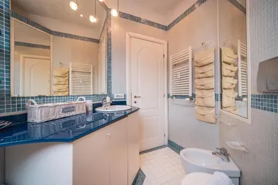 a bathroom with a toilet and a sink and a tub at St. Peter Hill BuddyRent in Rome