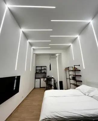 a white room with a bed and a tv at San Pietro love Apartament in Rome