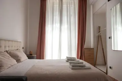 a bedroom with a bed with three towels on it at Casa Matteo53 Termini - Castro Pretorio in Rome