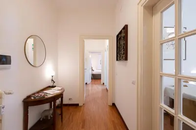 a hallway with a table and a mirror at Kimera Luxury Apartments in Rome San Pietro in Rome