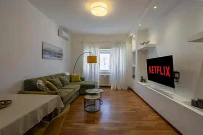 a living room with a couch and a tv at Kimera Luxury Apartments in Rome San Pietro in Rome