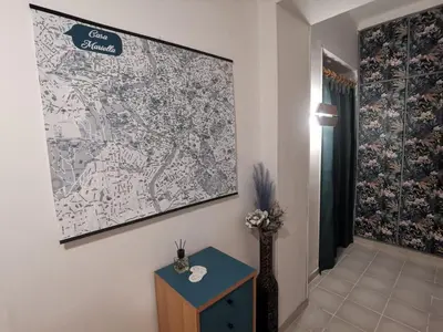 a large map hanging on a wall next to a table at Casa Mariella Quartiere Trionfale - Prati in Rome