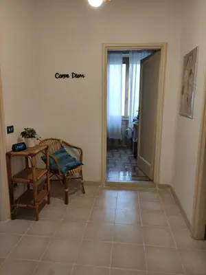 a hallway with a table and a chair in a room at Casa Mariella Quartiere Trionfale - Prati in Rome