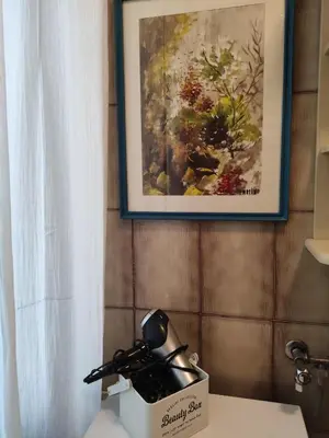 a telephone sitting on a table next to a painting at Casa Mariella Quartiere Trionfale - Prati in Rome