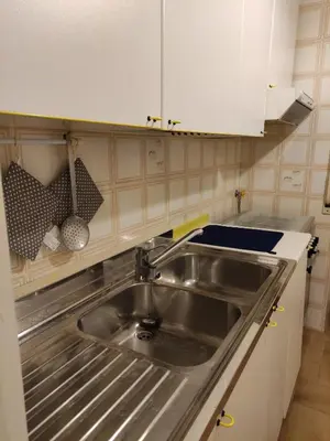 a kitchen with a stainless steel sink and white cabinets at Casa Mariella Quartiere Trionfale - Prati in Rome