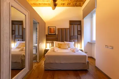 a bedroom with two beds and a mirror at Fontana di Trevi Roma Luxury Suite in Rome