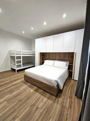 a bedroom with a large bed and white cabinets at Ricettiva Cipro San Pietro e Musei Vaticani in Rome