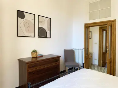 a bedroom with a bed and a dresser and a chair at RomeAsYouLike - Vatican Apartment N°73 in Rome