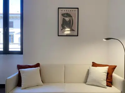 a white couch in a room with a picture on the wall at RomeAsYouLike - Vatican Apartment N°73 in Rome
