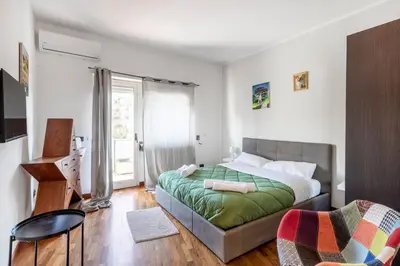 a bedroom with a bed with a green blanket at Vista Cupola San Pietro - Stazione Roma S Pietro in Rome