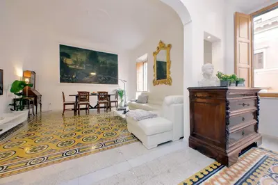a living room with a couch and a table at TreasureRome Opera & Trevi Grand Suite 3BR in Rome