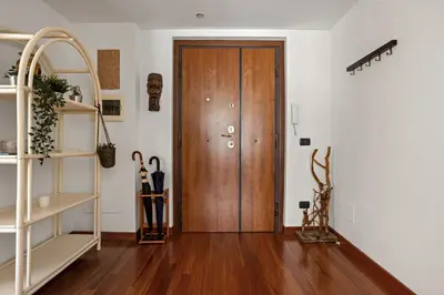 a hallway with a white book shelf and a door at 543 Appia Avenue - Metro A by RHR in Rome