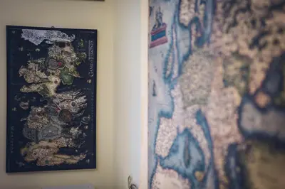 a map on a wall next to a picture at Da Alessia Per Dormire Al Coppedé in Rome