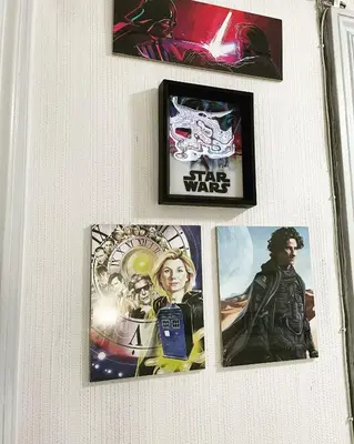 a group of pictures hanging on a wall at Da Alessia Per Dormire Al Coppedé in Rome