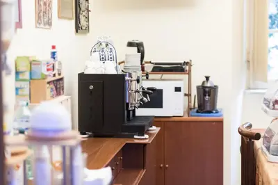 a kitchen counter with a microwave and a coffee maker at Da Alessia Per Dormire Al Coppedé in Rome