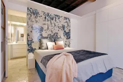 a bedroom with a bed and a bathroom at Luxury apartment in Rione Monti in Rome