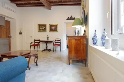 a living room with a table and chairs at Luxury apartment in Rione Monti in Rome