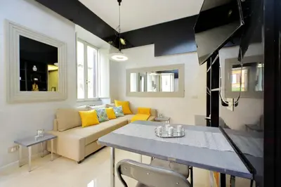 a living room with a couch and a table at Charming loft with terrace at the Quirinale in Rome