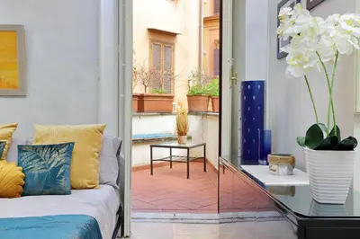 a living room with a couch and a glass table at Charming loft with terrace at the Quirinale in Rome