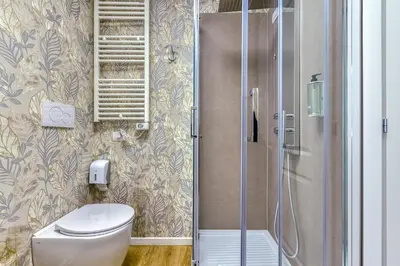a bathroom with a toilet and a shower at ROME'S GLORIA HOTEL in Rome