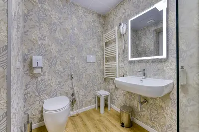 a bathroom with a sink and a toilet and a mirror at ROME'S GLORIA HOTEL in Rome