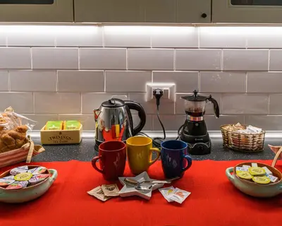 a counter top with cups and dishes on a table at Rainbow Vatican home in Rome