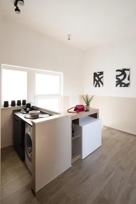 a kitchen with a washer and a washing machine at Japandi Space by Nosdom Properties in Rome