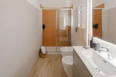 a white bathroom with a toilet and a sink at Japandi Space by Nosdom Properties in Rome