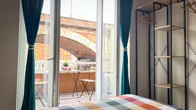 a bedroom with a window with a view of a bridge at Ele rooms San Pietro in Rome