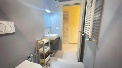 a bathroom with a sink and a toilet and a mirror at Ele rooms San Pietro in Rome