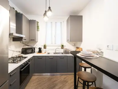 a kitchen with gray cabinets and a sink and a counter at Casa TPZ Metro Baldo - Close To Vatican in Rome