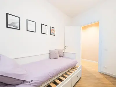 a white bedroom with a bed and a mirror at Casa TPZ Metro Baldo - Close To Vatican in Rome