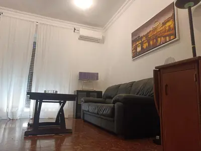 a living room with a couch and a table at Beauty apartment in the green, direct link with center in Rome