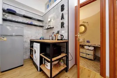 a kitchen with a counter and a refrigerator at St. Peter - Loft at 50m from Metro (up to 4) in Rome